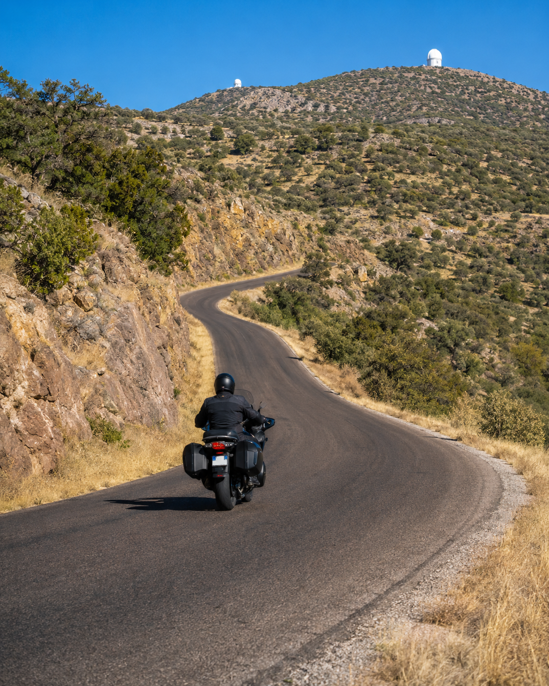 Motorcyclist riding Highway 118 through the Davis Mountains in Texas